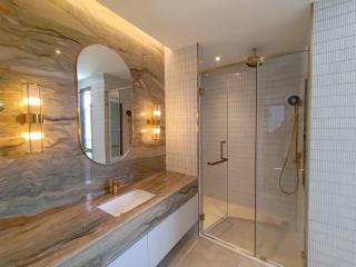 Modern bathroom with glass shower and unique marble sink