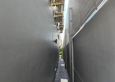 Narrow outdoor alleyway between two buildings