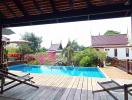 Spacious outdoor area with swimming pool and wooden deck