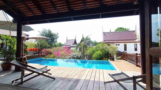 Spacious outdoor area with swimming pool and wooden deck