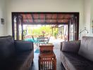 Spacious living room with open patio doors leading to an outdoor area