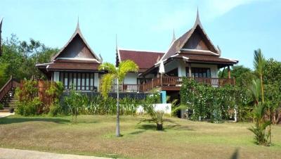 Traditional style house with gabled roofs, front yard, and balcony