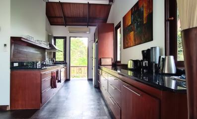 Spacious kitchen with modern appliances and wooden cabinets