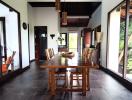 Spacious dining room with large wooden table and sliding glass doors