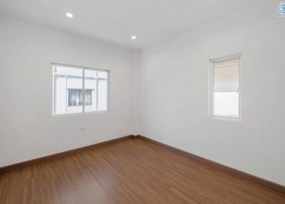 Empty bedroom with wooden floor and white walls