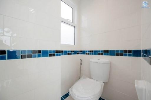 Clean and modern bathroom interior with white and blue tiles