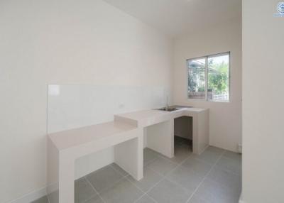 Minimalist kitchen with built-in countertop and natural light