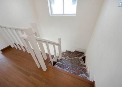 Bright and modern staircase with wooden steps and white rails