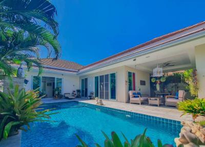 Bright and spacious outdoor living area with pool and lounging chairs