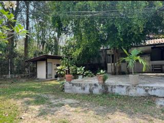 Rural house exterior with green surroundings and a spacious yard