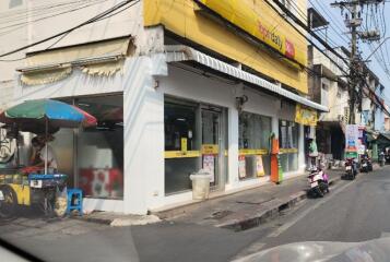 Street view of a commercial building with storefronts