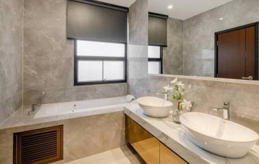 Modern bathroom with double vanity and large bathtub