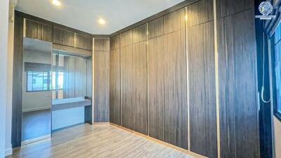 Spacious bedroom with large wardrobe and hardwood flooring