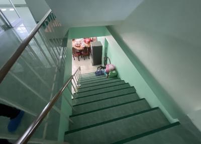 Staircase leading to a lower floor with dining area visible