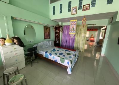 Spacious bedroom with traditional wooden bed and colorful decor