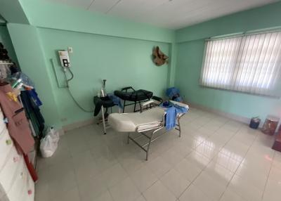 Spacious room with a massage table and light blue walls