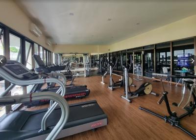 Spacious gym with modern equipment and large mirrors