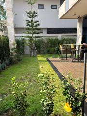 Spacious backyard with a wooden deck and green lawn