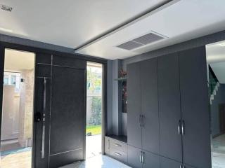 Modern bedroom with grey cabinetry and access to the outdoors