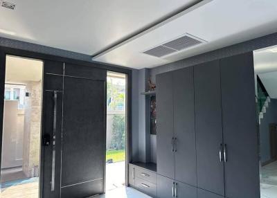 Modern bedroom with grey cabinetry and access to the outdoors