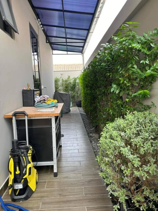Cozy outdoor patio with a garden and cleaning equipment