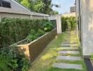 Beautiful garden walkway with wooden steps and lush greenery at a modern home