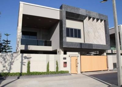 Modern two-story building with geometric design and wooden gate