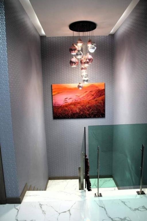 Modern bathroom interior with artistic lighting and wall decor