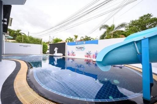 Private pool with waterslide and artistic wall mural