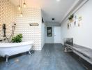 Spacious bathroom with a freestanding tub, modern lighting, and decorative plants