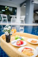 Cozy outdoor poolside dining setup with fresh fruit and snacks