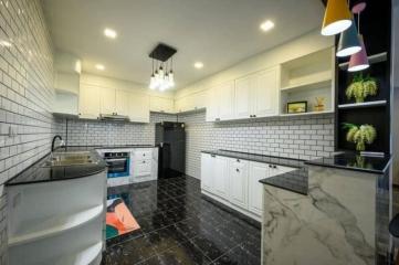 Modern kitchen with white cabinetry and subway tile backsplash