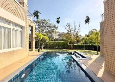 Luxurious home exterior with a swimming pool and landscaped garden