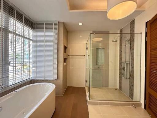 Bright modern bathroom with separate bathtub and walk-in shower