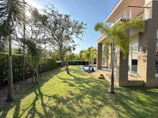 Modern home exterior with swimming pool and lush garden