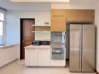 Modern kitchen with stainless steel appliances and wooden cabinets