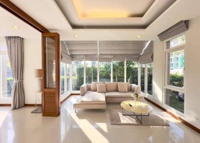 Bright and spacious living room with large windows and modern decor