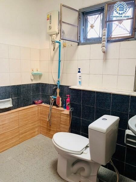 Compact bathroom with window and tiled walls