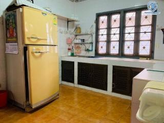 Spacious kitchen with vintage refrigerator and tiled flooring