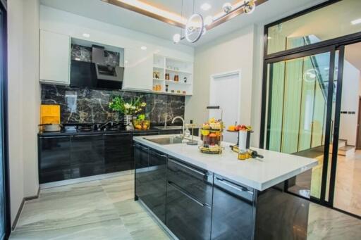 Modern kitchen with black countertops and stainless steel appliances