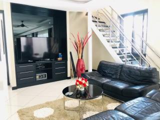 Spacious living room with modern furniture and staircase