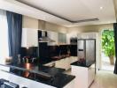 Modern kitchen with stainless steel appliances and garden view