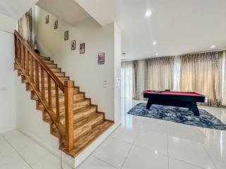 Elegant living space with staircase and pool table