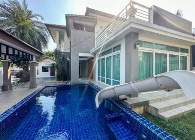 Modern two-story house with a pool and slide