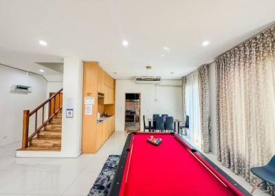 Spacious living room with billiard table and open kitchen