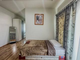 Cozy bedroom with hardwood floors and tasteful decor