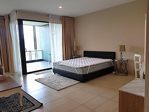 Spacious bedroom with king-sized bed and balcony access