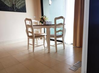 Cozy dining area with table and chairs by the window