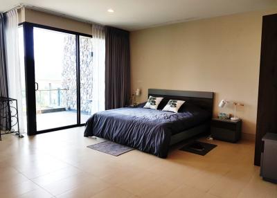 Spacious bedroom with modern decor and balcony access