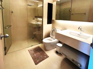 Modern bathroom with walk-in shower and wall-mounted toilet